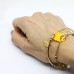 Bracciale bangle in acciaio color oro con foglia di ginkgo biloba