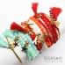 Bracciale bangle in acciaio color oro con ciondolo pesce e nappina