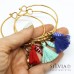 Bracciale bangle in acciaio color oro con ciondolo pesce e nappina
