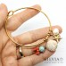 Bracciale bangle in acciaio color oro con conchiglia stella marina turchese e perla