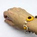 Bracciale con girasole, coccinella e margherita