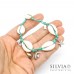 Bracciale elastico verde acqua con conchiglie e charms in acciaio a tema mare