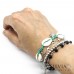 Bracciale elastico verde acqua con conchiglie e charms in acciaio a tema mare