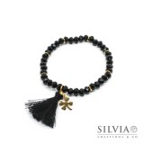 Bracciale elastico cristalli neri da 4x6 mm con nappina e quadrifoglio in acciaio color oro