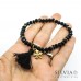 Bracciale elastico cristalli neri da 4x6 mm con nappina e quadrifoglio in acciaio color oro