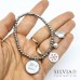 Bracciale elastico con perle acciaio pinguino e fiocco di neve