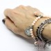 Bracciale elastico a tema Alice con cristalli, biscotto "eat" e charms