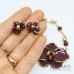 Collana girocollo e orecchini a lobo con orchidea bordeaux e oro