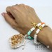 Bracciale cordino con perline heishi colorate e charms a tema mare color oro