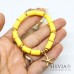 Bracciale elastico con perline heishi gialle e stella marina oro