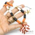 Collana cordino con perline heishi bianche arancio nere charms e rametto corallo