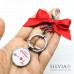 Portachiavi natalizio con scritta Merry Christmas e charms